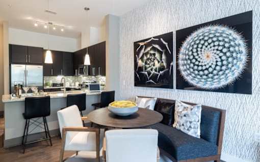 A modern kitchen with a dining table set for four at Mira Upper Rock, Maryland, 20850