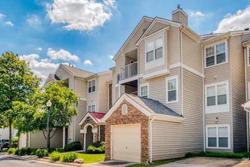 Multistory residential buildings with beige siding at Park at Winterset Apartments, Owings Mills