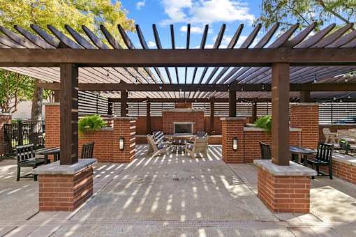 A patio with a table and chairs under a wooden pergola at Prairie Crossing, Texas