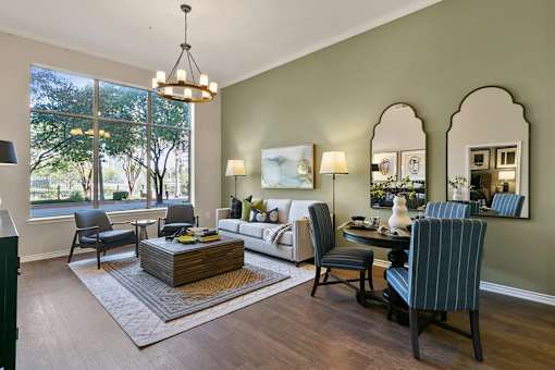 A living room with a sofa, chairs, and a coffee table at Prairie Crossing, Farmers Branch