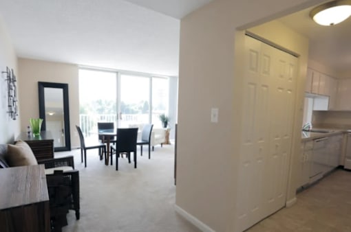 A living room with a dining table and chairs is shown.
