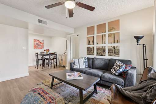 A living room with a grey couch and a coffee table at Riviera Park, Chandler Arizona