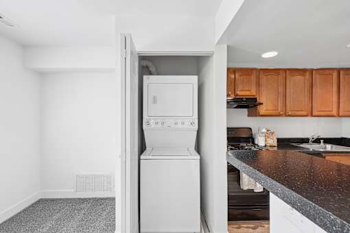 Stackable washer and dryer in laundry closet at The Brook At Columbia Apartments, Columbia, MD 21044