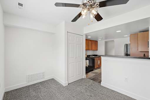 Open concept living and dining area with kitchen view at The Brook At Columbia Apartments, Columbia, MD
