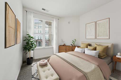 A bedroom with a large bed and a window with blinds.