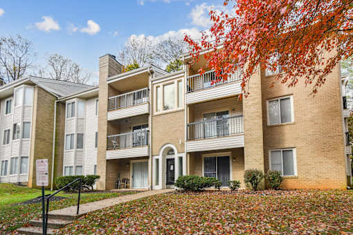 Apartment building with a sign in front of it  at Poplar Glen Apartments, Columbia, MD, 21044.