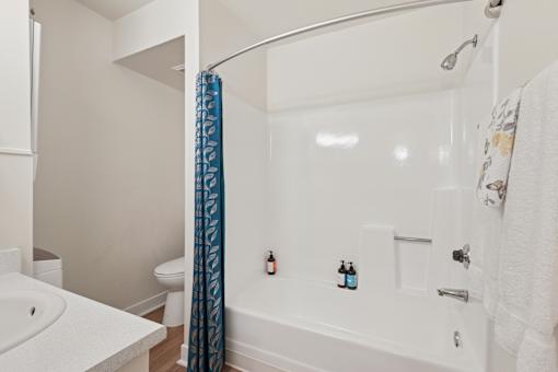 A white bathroom with a white tub and a white toilet at Riviera Park, Chandler Arizona