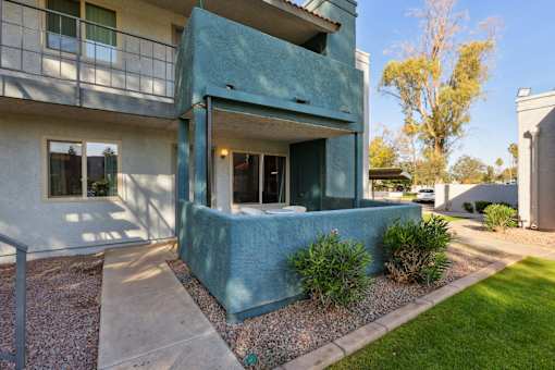 A blue house with a white wall and a window at Riviera Park, Chandler Arizona
