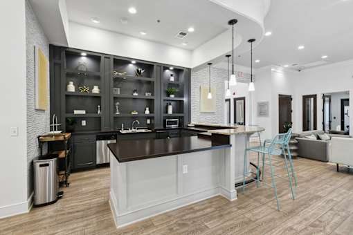 A modern kitchen with a large island and a dining area  at Poplar Glen Apartments, Columbia, MD, 21044.