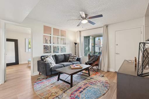 A living room with a grey couch and a coffee table at Riviera Park, Chandler Arizona