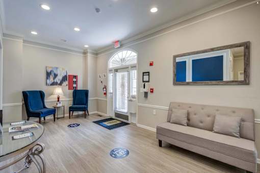 Resident lobby with seating and entrance at Park at Winterset Apartments, Owings Mills, MD 21117
