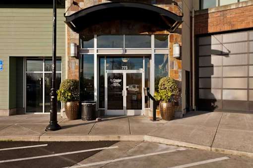 A building with a large glass door and a sign that reads 777 on it.
