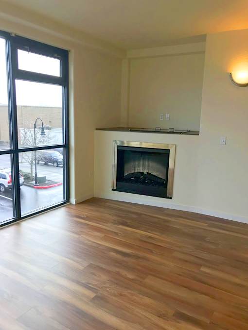 A room with a fireplace and sliding glass doors.