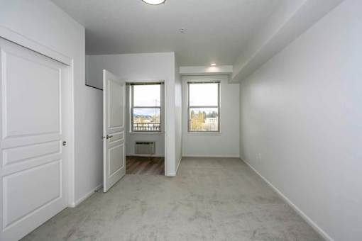 A white room with a door and a window.