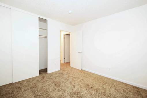 A room with a carpeted floor and white walls.