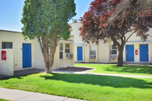 an exterior view of a building with blue doors
