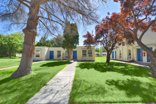 a sidewalk in front of a group of houses