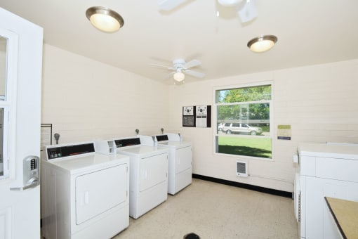 the laundry room is equipped with washers and dryers