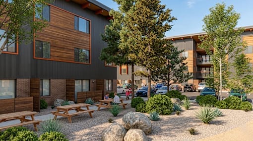 A modern building with wooden accents and a landscaped courtyard.