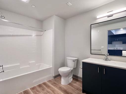 A white toilet sits next to a white sink in a bathroom.