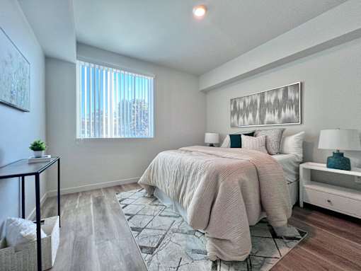 A bedroom with a large bed and a window.