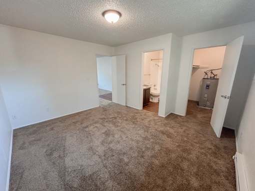 A room with carpeted floor and white walls.