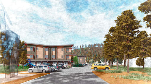 A parking lot with cars and a yellow taxi in front of a building.