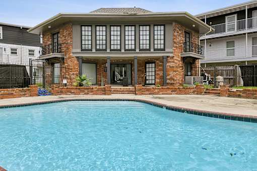 A house with a pool in front.