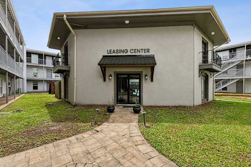 A leasing center is located in a grassy courtyard.