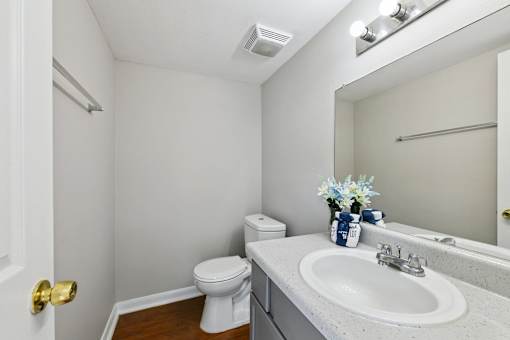 A white toilet sits next to a sink in a small bathroom.