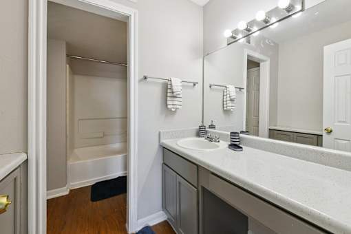 A bathroom with a white sink and a white door.