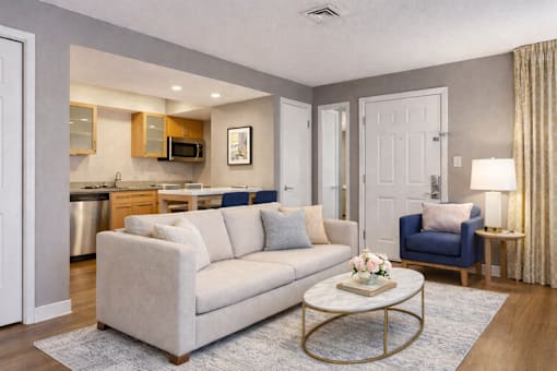 A living room with a white couch and a coffee table.