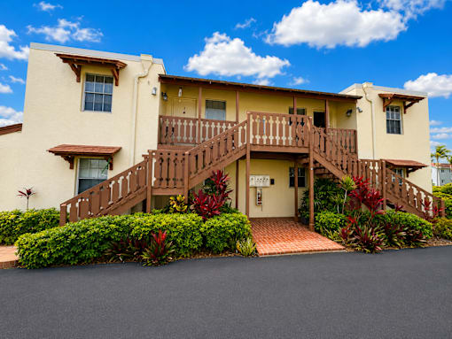 475 - A two-story house with a red brick walkway leading to the front door.