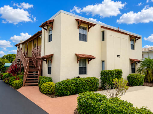 475 - BUILDING EXTERIOR - A two-story house with a staircase leading to the second floor.