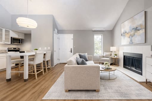 A modern living room with a fireplace and a dining area.