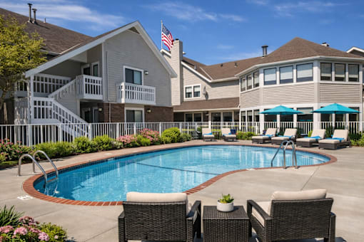 A large house with a pool in the backyard.