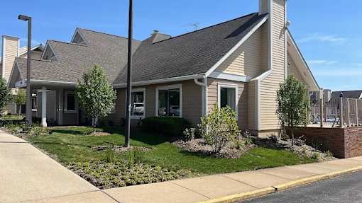 A house with a grey roof and a green lawn in front.