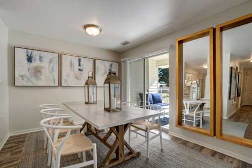 A dining room with a table and chairs.