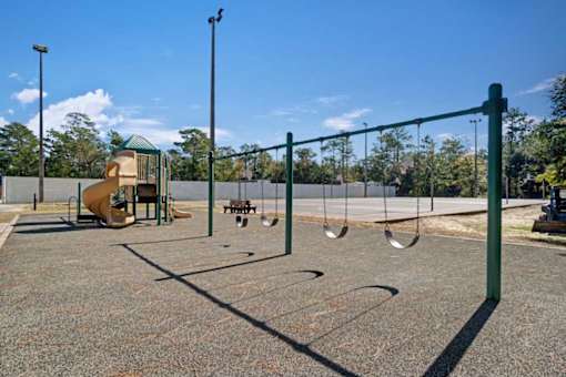 A playground with a swing set and a slide.