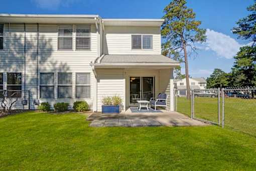 A house with a white exterior and a covered patio area.