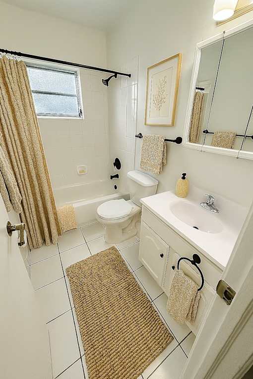 A bathroom with a toilet, sink, and shower.