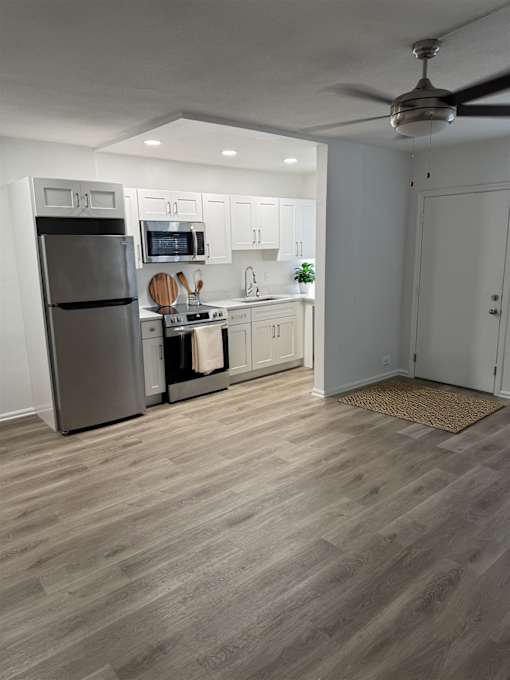 A kitchen with a refrigerator, stove, and oven.