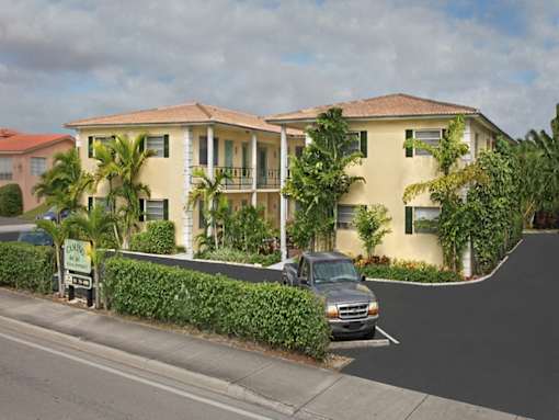 A house with a car parked in front of it.
