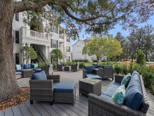 Quiet patio with seating under the shade of a large oak tree