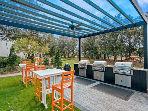 a patio with a table and chairs under a blue roof