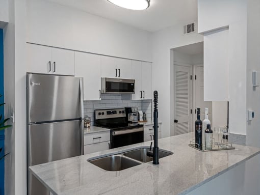 a kitchen with stainless steel appliances and a counter top