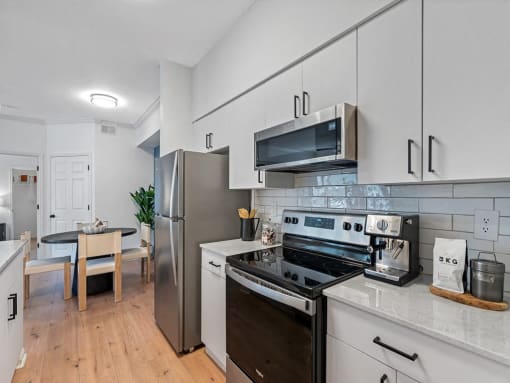 a kitchen with stainless steel appliances and white cabinets