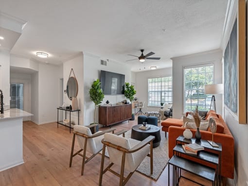 a living room with furniture and a ceiling fan