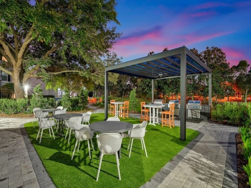 a patio with tables and chairs and a pergola