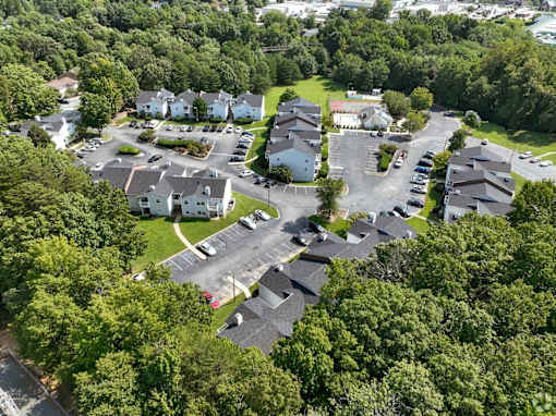A bird's eye view of a residential area with houses and cars at Sedgefield Square Apartments, Greensboro, NC, 27407